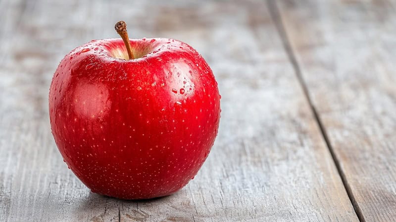 Red apple on wooden table